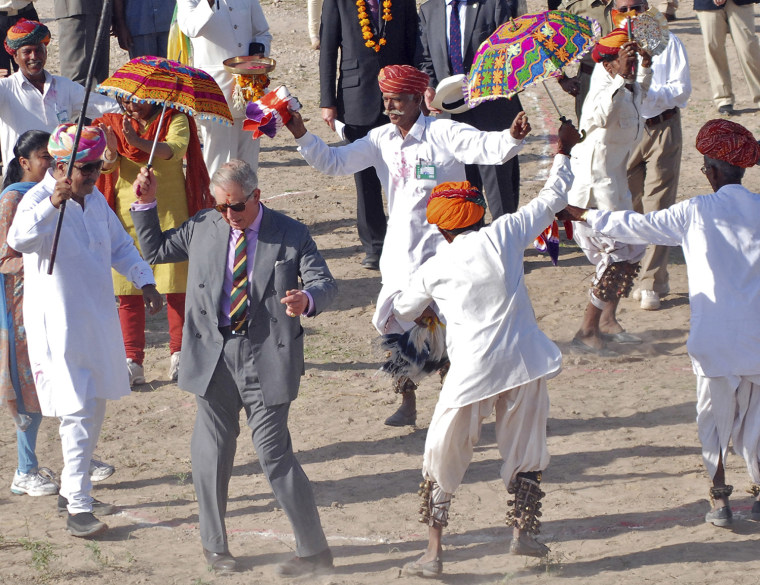 Image: Britain's Prince Charles dances with villagers at Tolasar